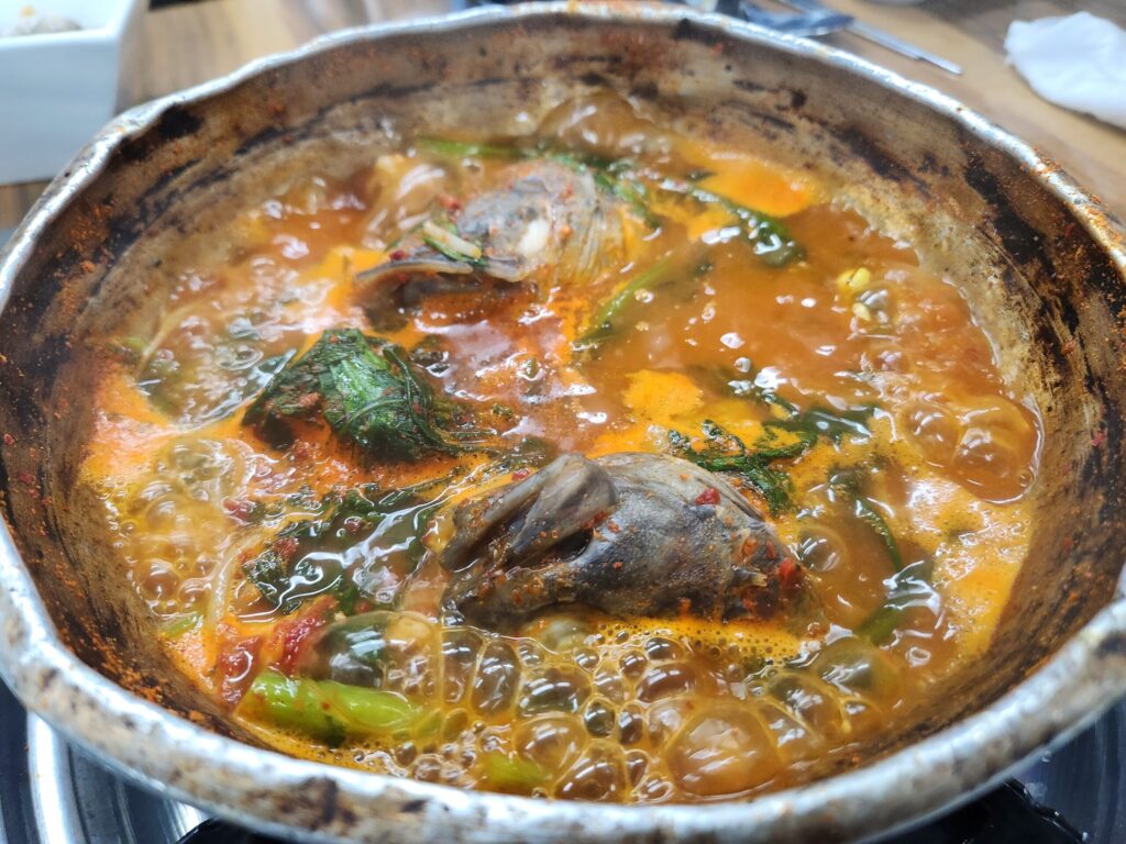 양은 냄비에 담겨 보글보글 끓고 있는 생선 매운탕의 모습.