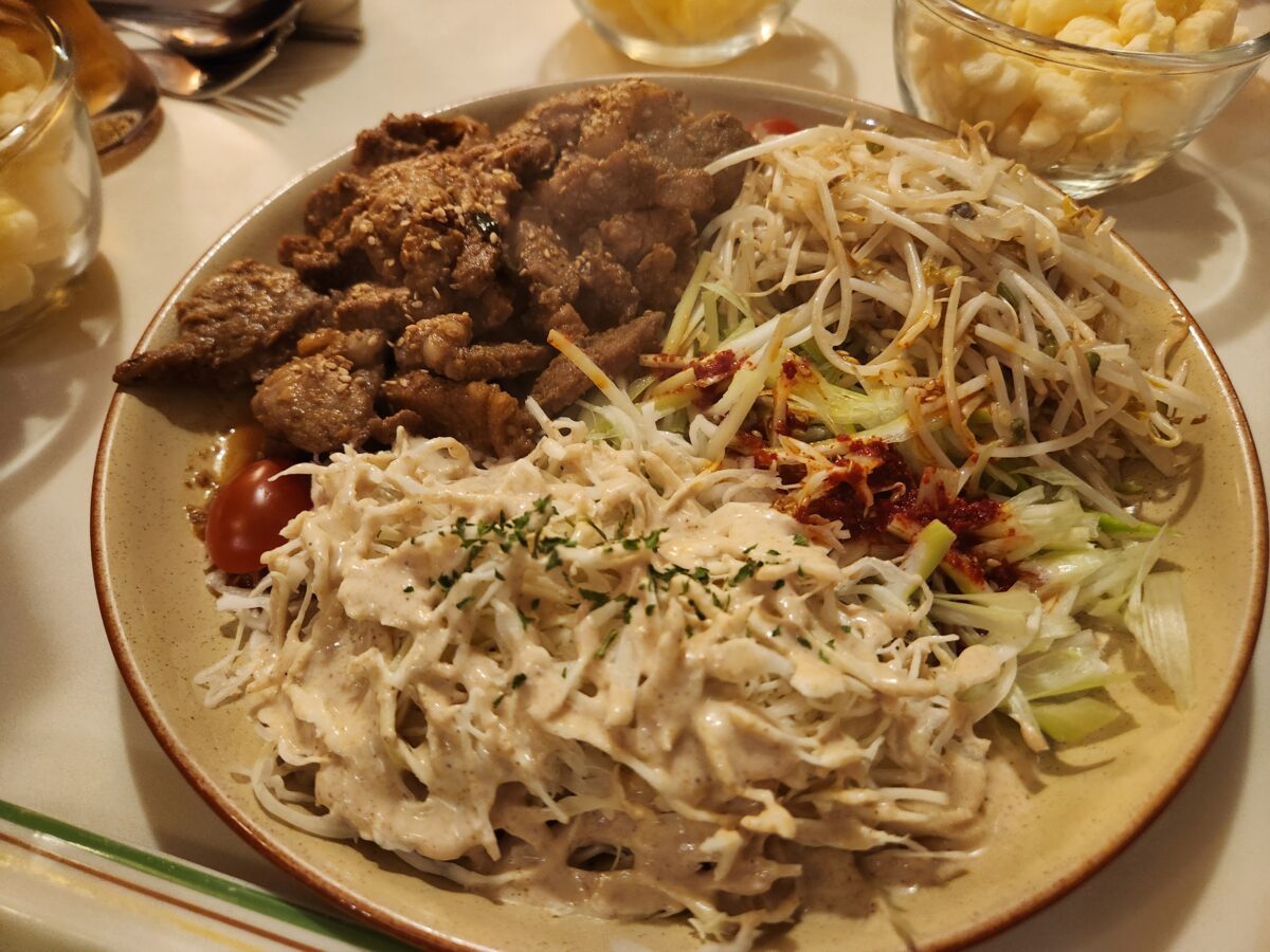 접시에 담긴 목살맥적구이와 숙주볶음