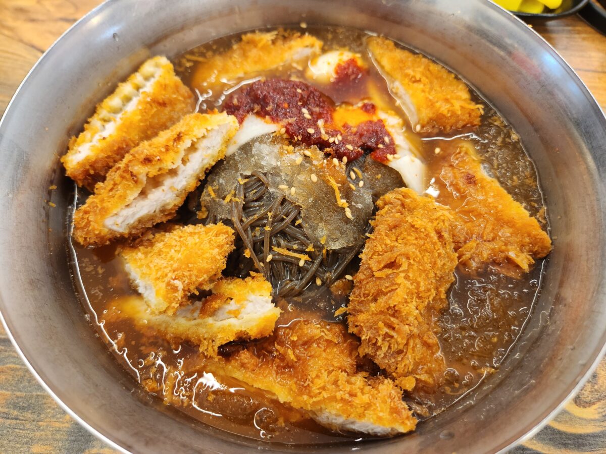 냉면 위에 바삭한 돈까스가 올려진 돈불물냉면